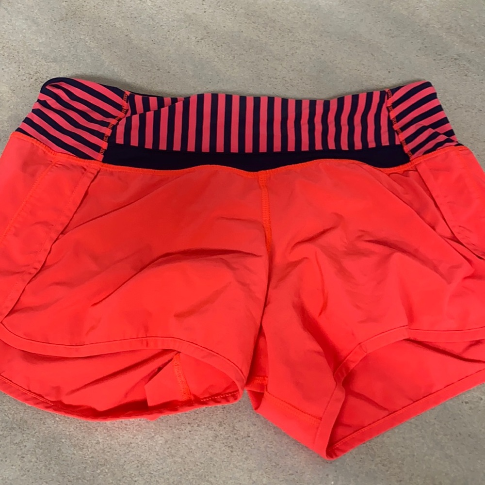 Lulu athletic shorts in great shape. Orange and blue stripe and orange.